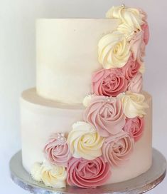 a white and pink cake with flowers on it