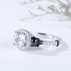 an engagement ring with a cushion cut diamond surrounded by round diamonds