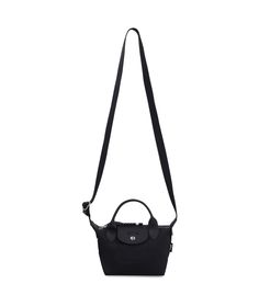 a black handbag on a white background with the strap hanging down to it's side