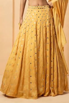 Gold attached cancan lehenga with mirror, bead, pearl embellishment. Paired with halter neck embellished padded blouse and dupatta. - Aza Fashions Kundan Dresses For Festivals And Parties, Kundan Dresses For Diwali Party, Festive Gota Work Lehenga For Parties, Festive Dress With Gota Work For Reception, Festive Embellished Georgette Skirt, Festive Floor-length Embellished Skirt, Embellished Floor-length Festive Skirt, Navratri Wedding Skirt With Mirror Work, Wedding Skirt With Mirror Work For Navratri