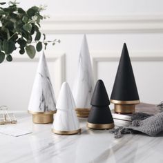 marble and brass christmas trees on a table