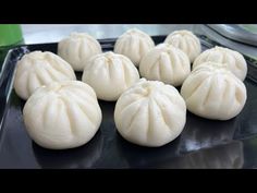 some dumplings are sitting on a black plate