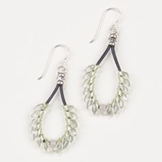 two pairs of earrings with beads hanging from the end of each earring, on a white background