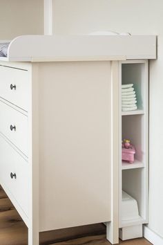 a baby crib in the corner of a room next to a dresser and bed