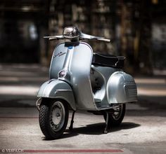 a silver motor scooter parked on the street