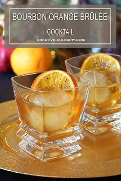 bourbon and orange brulee cocktail served in glass cups on a gold tray with christmas decorations