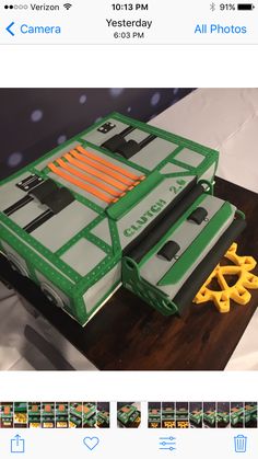 a cake made to look like the back of a green truck with orange and white stripes