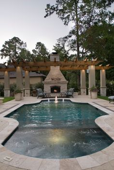 a pool with a fire place in the middle