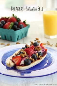 the breakfast banana split has berries and nuts on it