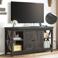 a flat screen tv sitting on top of a wooden entertainment center