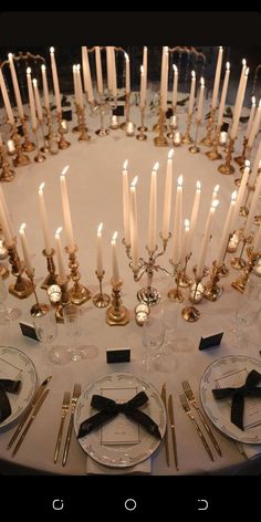 the table is set with candles and place settings