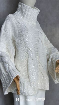 a mannequin wearing a white sweater with sequins