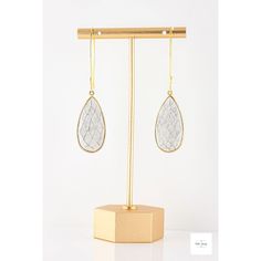 You are going to WOW in These White Howlite Drop Earrings! They are a beautiful addition to any jewelry collection. The white, pear-shaped faceted howlite stones are set in vermeil bezels, the grey pattern creating a blurred, scale-like effect. The gold-plated fancy ear wires complete the look. These earrings measure 2.7 inches in length. These White Howlite Drop Earrings are the perfect way to stand out! Whether you are dressing up for a night out or just want to add a touch of elegance to your White Wire-wrapped Drop Crystal Earrings, White Wire Wrapped Drop Crystal Earrings, White Wire Wrapped Drop Earrings, Howlite Jewelry, Howlite Stone, Artisan Rings, White Howlite, Gemstone Jewelry Handmade, Grey Pattern