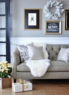 a living room filled with furniture and pictures on the wall