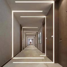 an empty hallway is lit up with white lights