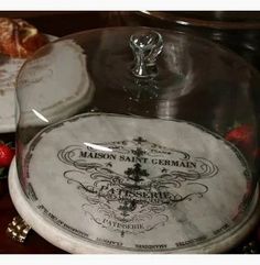 there is a cake under a glass dome on top of a table with strawberries