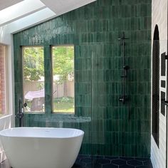 a bath tub sitting in the middle of a bathroom next to a walk in shower