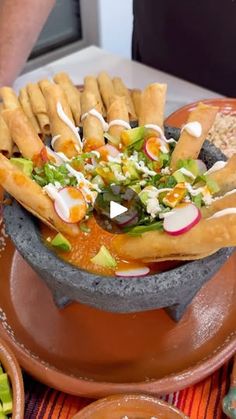 a bowl filled with lots of food on top of a table