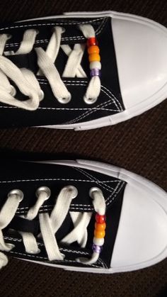 black and white sneakers with colorful beads on them