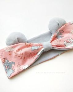 a bow tie with an animal design on it's head is laying on a white surface