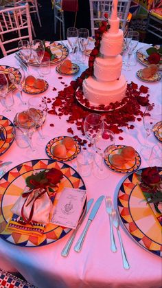 an image of a table set for a wedding reception with plates and forks on it