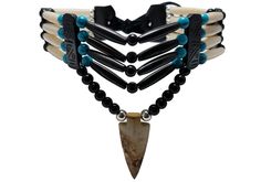 - Made from authentic buffalo bone hairpipe beads, genuine leather, 6 mm round metal beads, 6 mm synthetic round beads, and Picture Jasper stone. - 13.5 inches long (without the leather ties). - Hand carved Picture Jasper stone arrowhead pendant. - 100% Handmade by an artisan. - 4 strand traditional tribal bone choker. All of our jewelry is finely hand crafted in the united states using the finest materials available today. You can expect the best quality and craftsmanship in every piece we make Bone Choker, Arrowheads Design, Native American Crafts, Native Jewelry, Picture Jasper, Choker Necklaces, Mens Accessories Fashion, Handmade Beads, American Jewelry