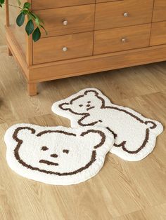 two rugs with teddy bears on them in front of a dresser and chest drawers