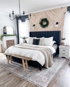 a bedroom with wood paneling and white bedding in the center is decorated with wreaths