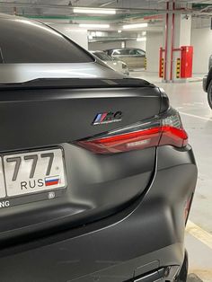 two cars parked in a parking garage next to each other