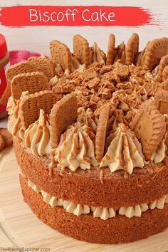 a close up of a cake on a plate with frosting and cookies in the background