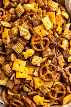 cheesy snack mix in a bowl with pretzels and waffles