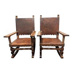 a pair of wooden chairs sitting next to each other