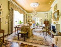 a living room filled with furniture and a chandelier