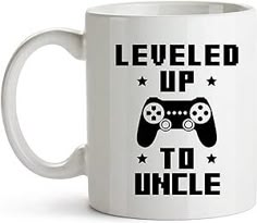 a white coffee mug with the words level up to uncle on it and a video game controller