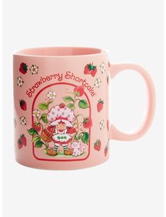 a pink mug with strawberry shortcakes on it