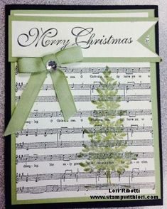 a christmas card with sheet music and a green bow on it's front side