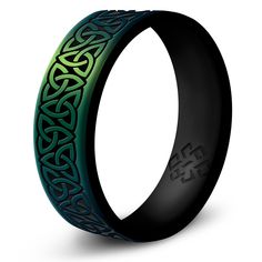 a black and green ring with an intricate design