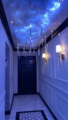 an empty hallway with lights hanging from the ceiling and clouds in the sky above it