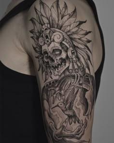 a woman's arm with a tattoo design on it and a skull in the middle