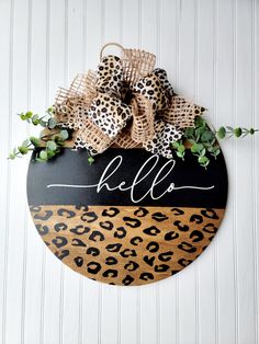 a leopard print and burlock monogrammed sign with the word hello on it