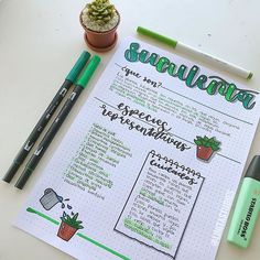 a notepad with some writing on it next to two pens and a potted plant