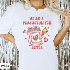 a woman wearing a white t - shirt that says we're a perfect match