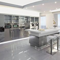 a modern kitchen with stainless steel appliances and white marble countertops is featured in this ad for fedisha furniture