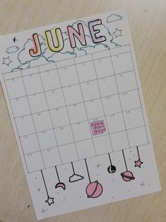 a calendar on a wooden table with the date june