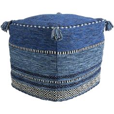 a blue and white round poufle with tassels on the top, sitting in front of a white background