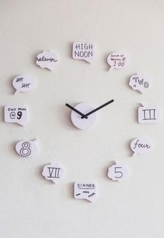 a clock made out of white paper with speech bubbles and numbers on the face that read high noon