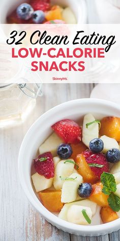 a white bowl filled with fruit next to a cup of tea