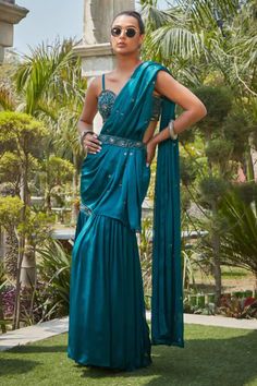 Teal green pre-draped concept saree with sequin embroidery and attached drape. Comes with an embroidered blouse embellished by beads and sequins and belt. - Aza Fashions Fitted Embellished Draped Sharara, Pre-draped Wedding Sets, Embellished Draped Sharara For Reception, Traditional Draped Embellished Sharara, Bollywood Style Embellished Draped Sharara, Embellished Draped Sharara For Diwali, Designer Pre-draped Sets With Traditional Drape, Designer Wear Sets With Pre-draped Traditional Drape, Embellished Pre-draped Saree For Wedding