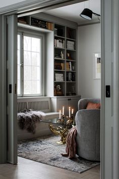 a living room filled with furniture next to a window