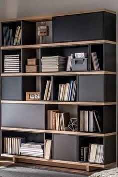 a bookshelf filled with lots of books in a room